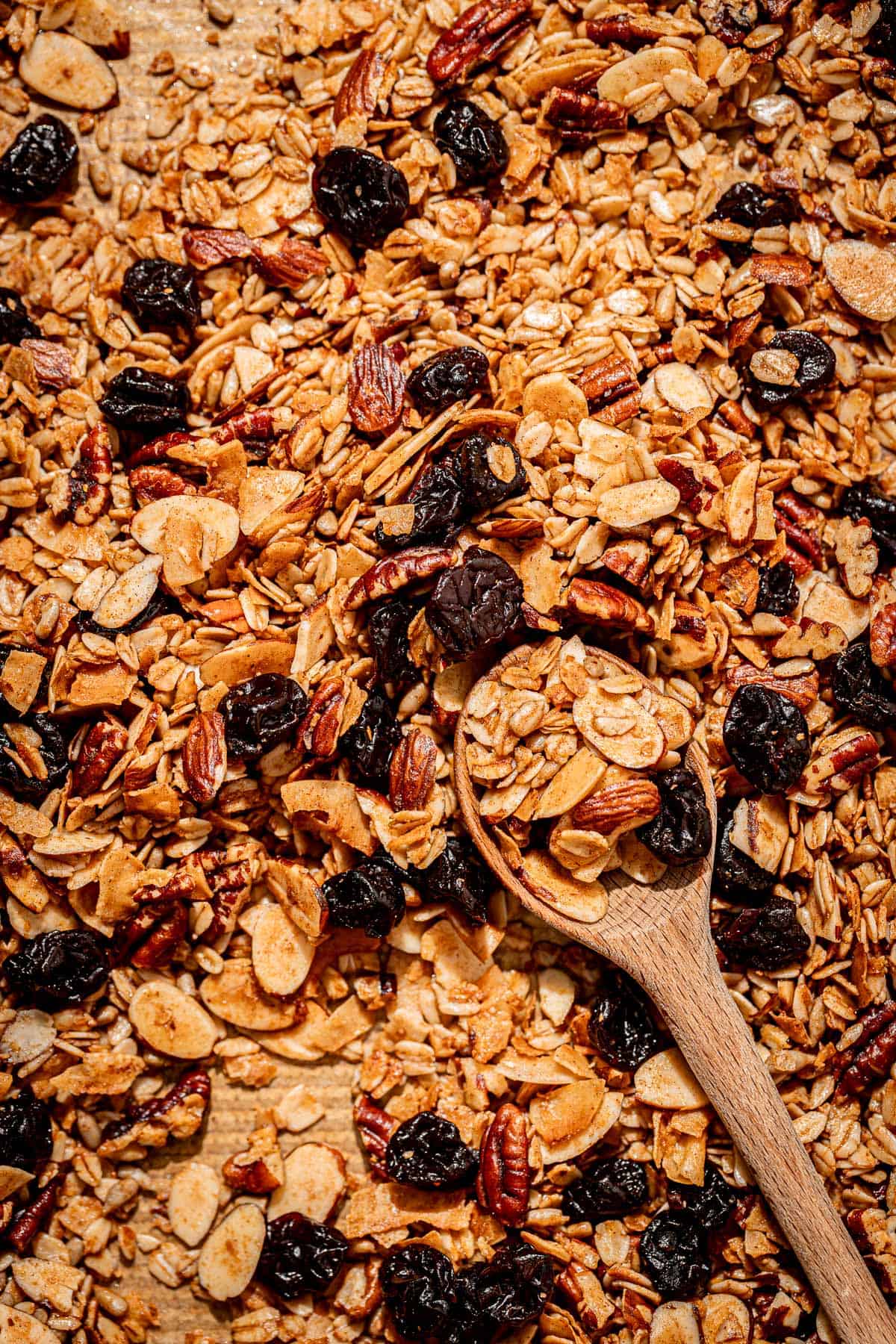 close up shot of maple nut granola with a wooden spoon.