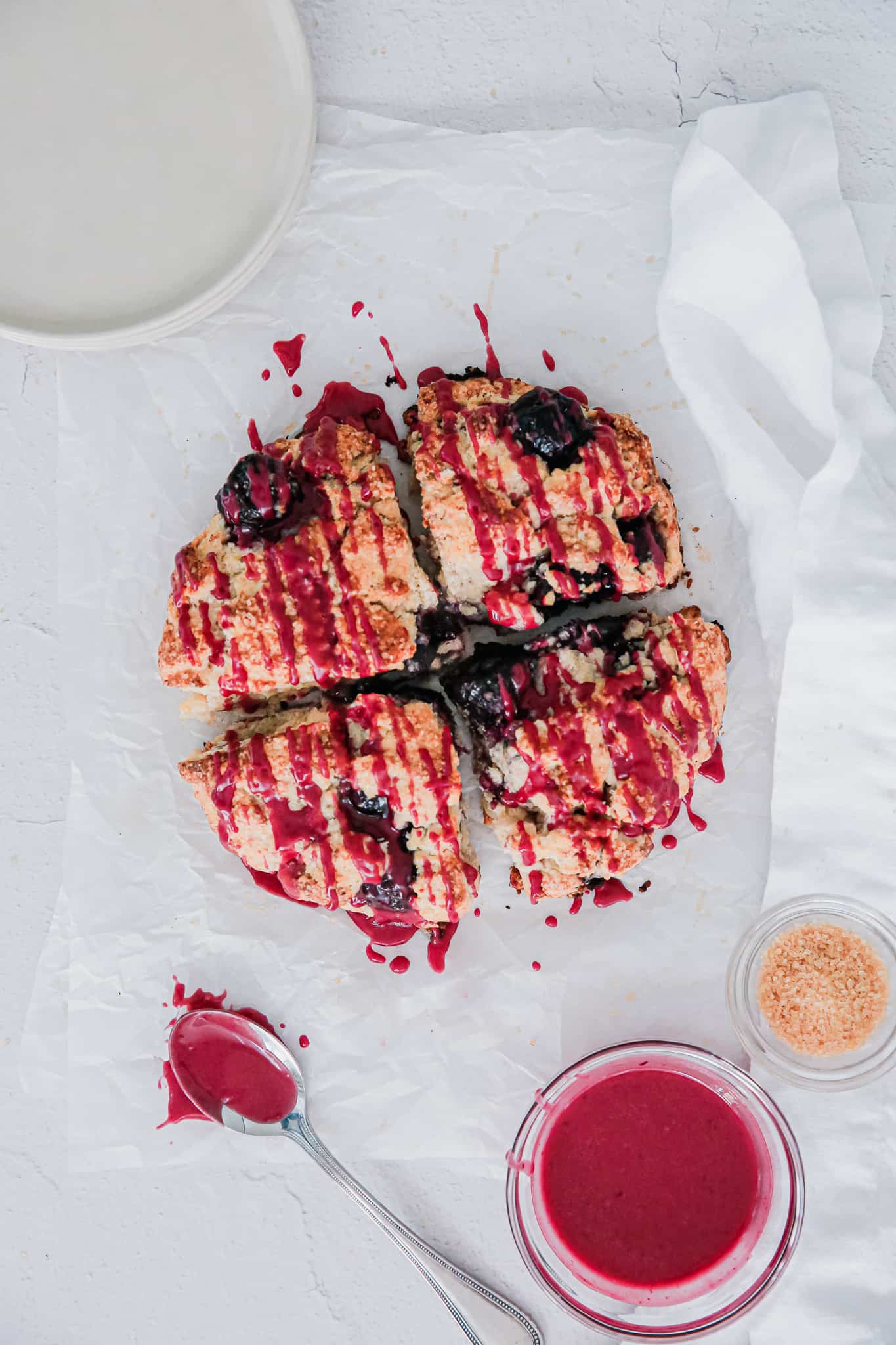 cherry scones with glaze drizzled over the top.