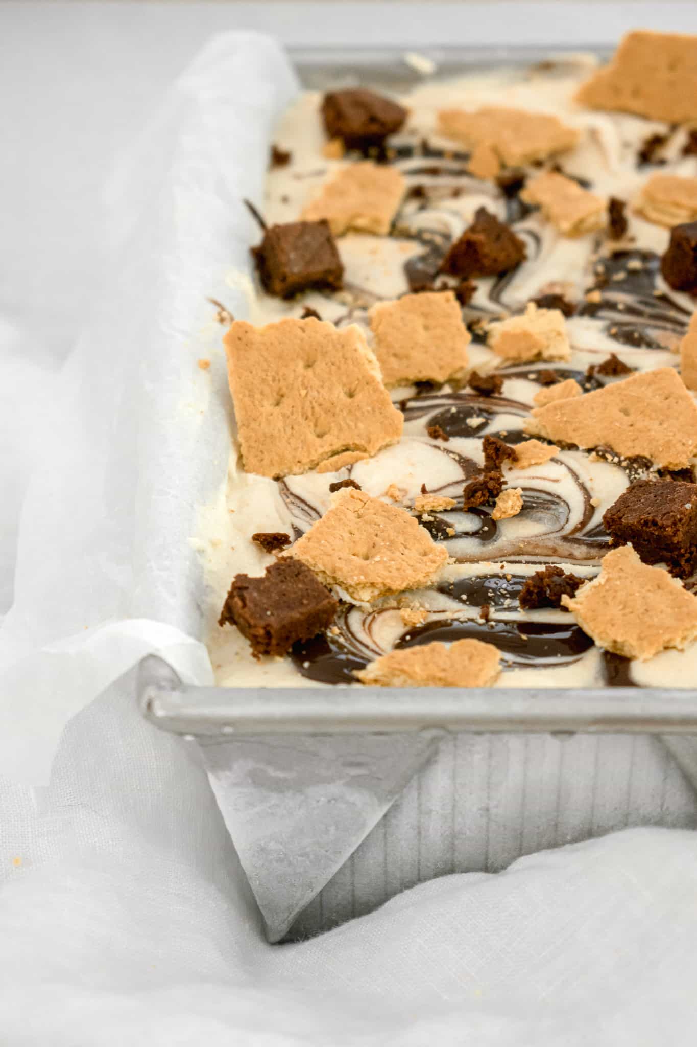pan of graham ice cream with graham crackers and brownies on top.