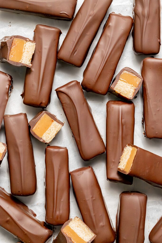 homemade Twix bars on parchment paper. 
