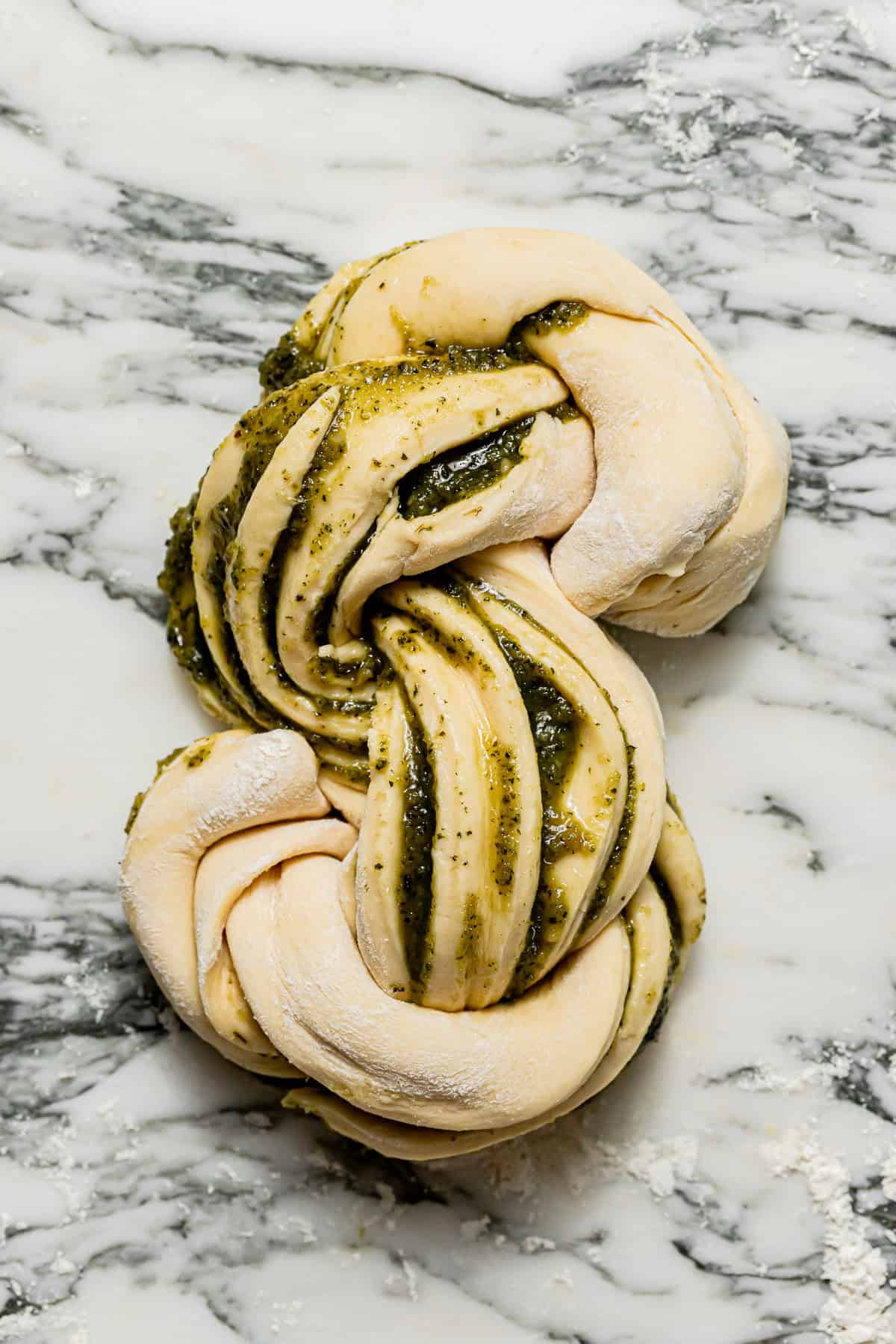 shaped pesto swirl bread on marble. 