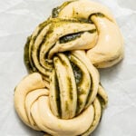 pesto swirl bread unbaked on parchment paper.