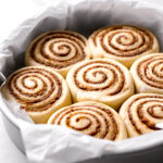 cardamom cinnamon rolls proofed in parchment lined cake pan