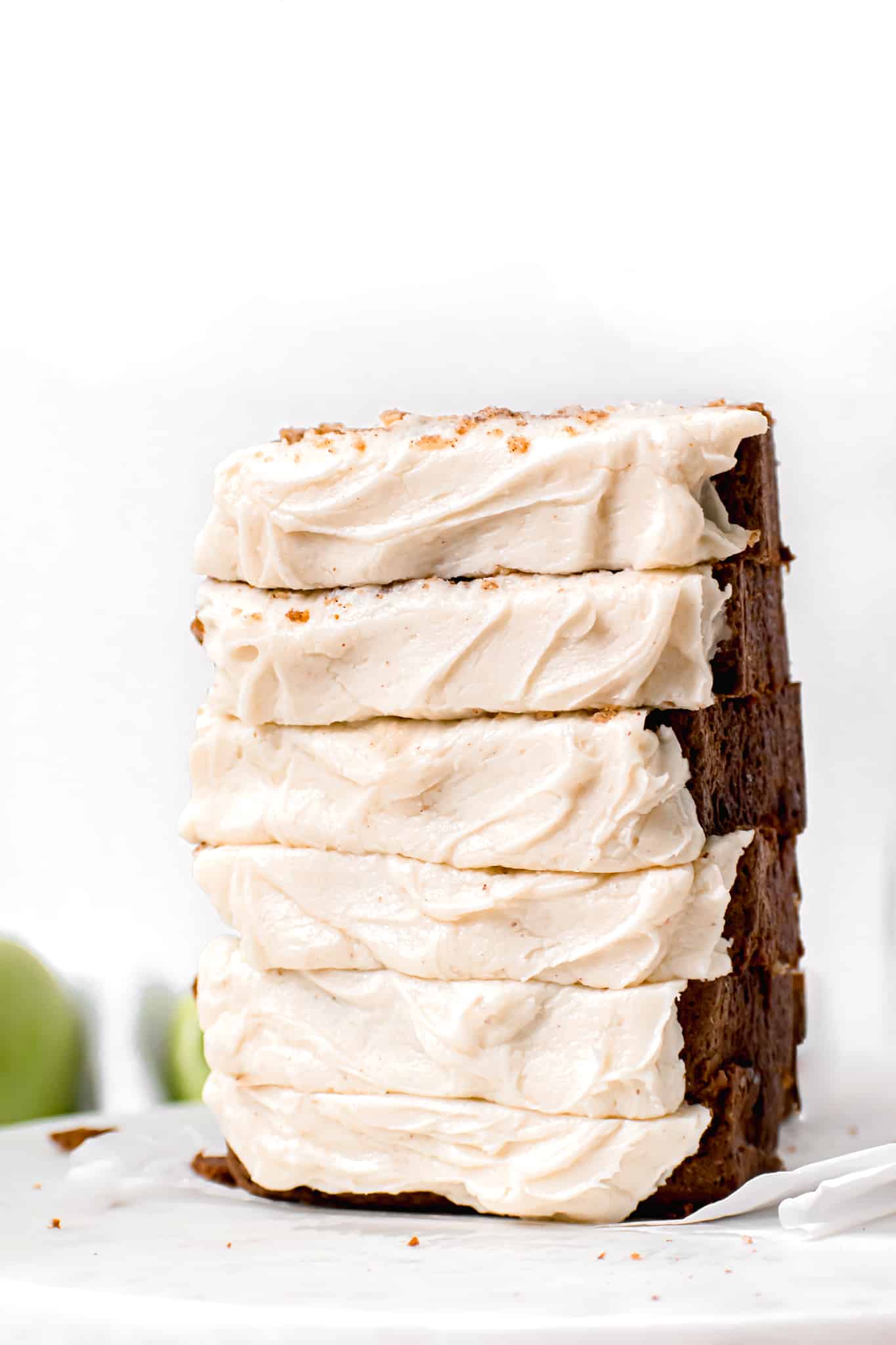Apple Spice Loaf Cake with Brown Butter Cream Cheese Frosting slices stacked upright.