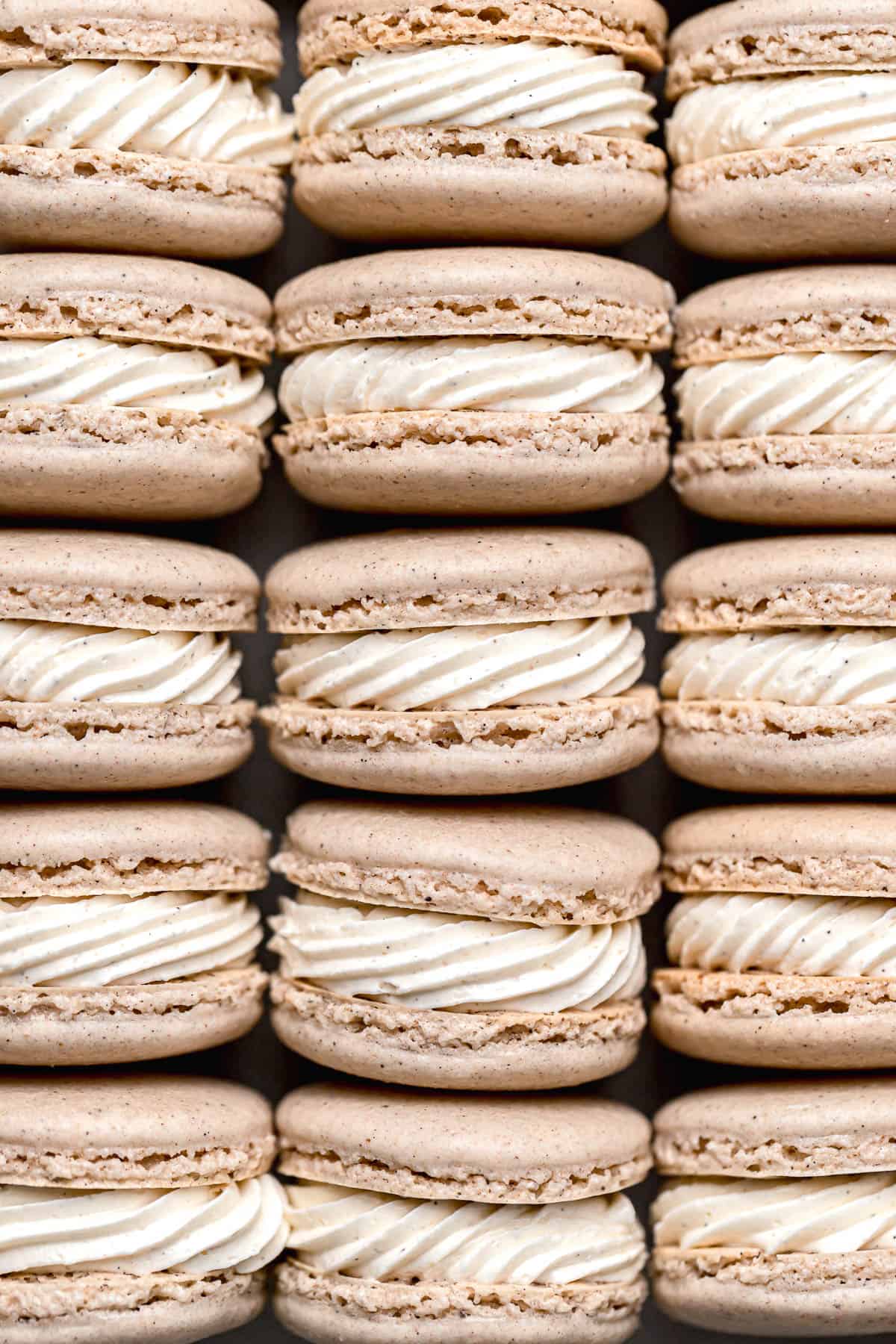 chai macarons with swiss meringue buttercream lined up.
