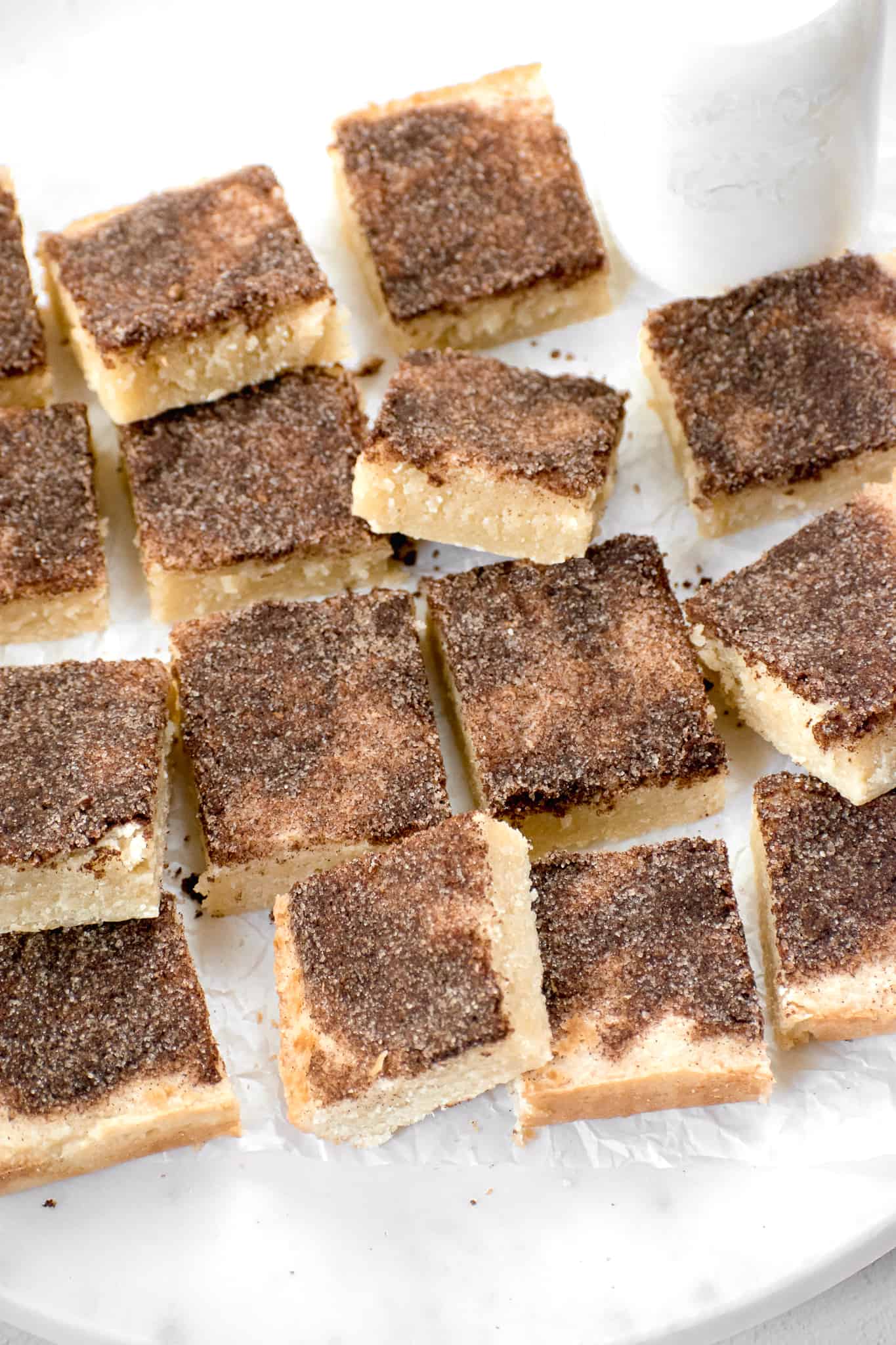snickerdoodle cookie bars arranged on parchment paper.