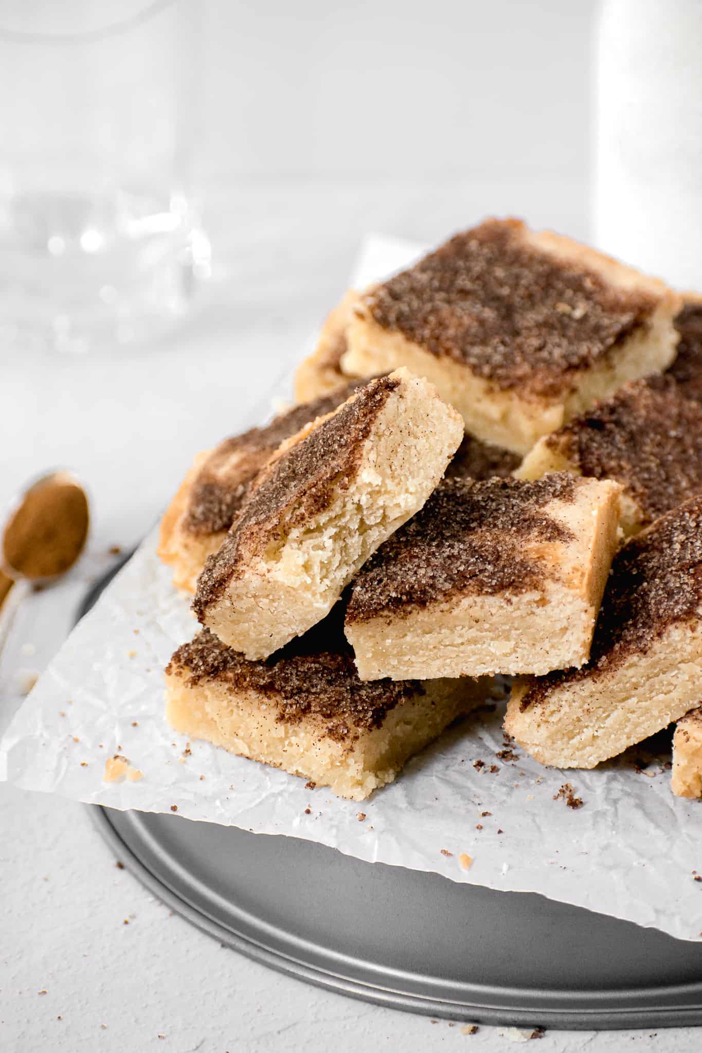 snickerdoodle cookie bars piled on a plate.