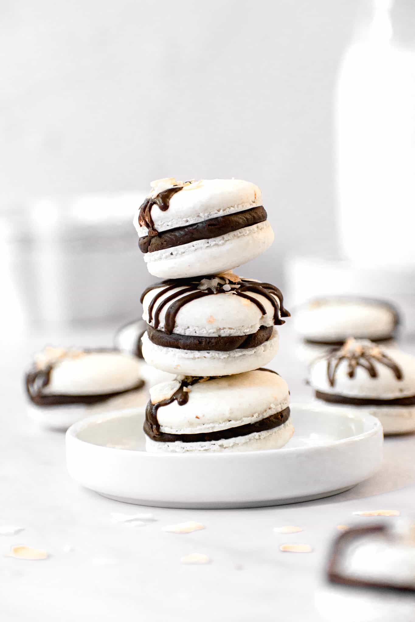 three macarons stacked on top of each other on a small plate.