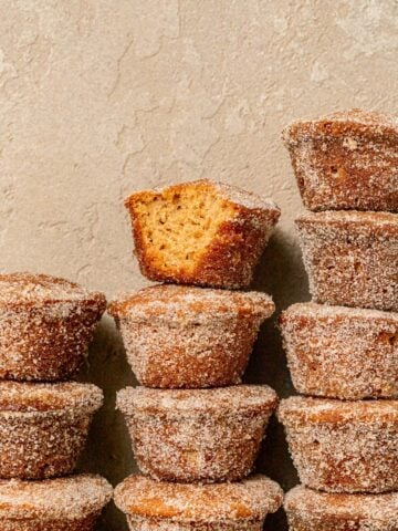 mini apple cider donut muffins stacked in three columns.