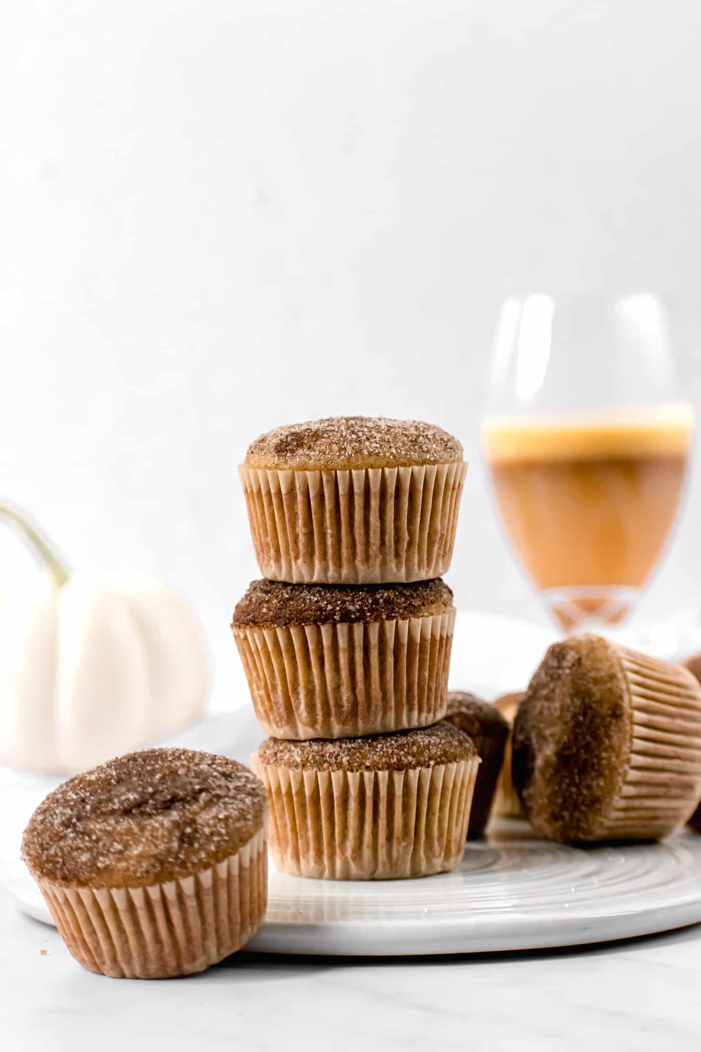apple cider donut muffins stacked on top of each other.