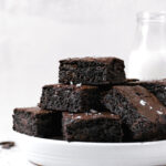 brown butter brownies piled on white plate
