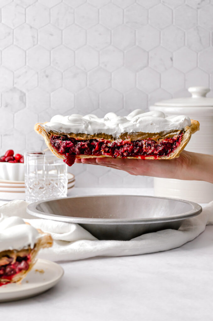ginger molasses cranberry pie held up with one hand