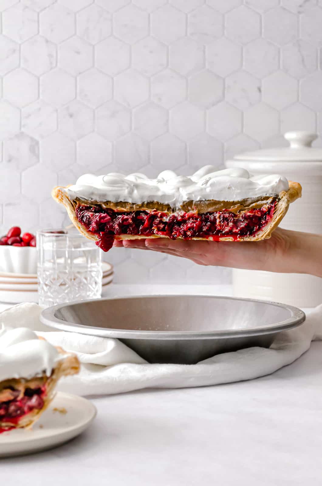ginger molasses cranberry pie held up with one hand.