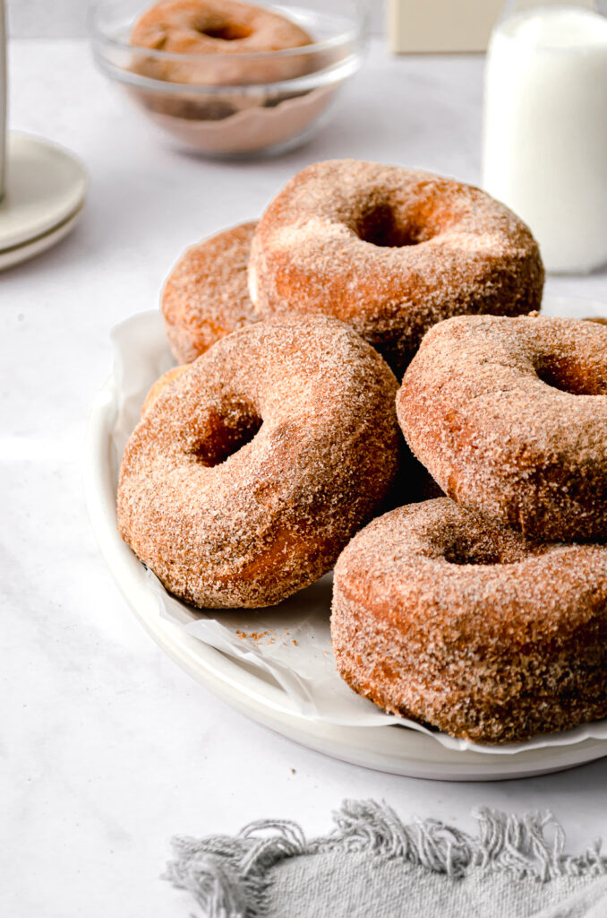 cinnamon sugar buttermilk brioche donuts on white plate