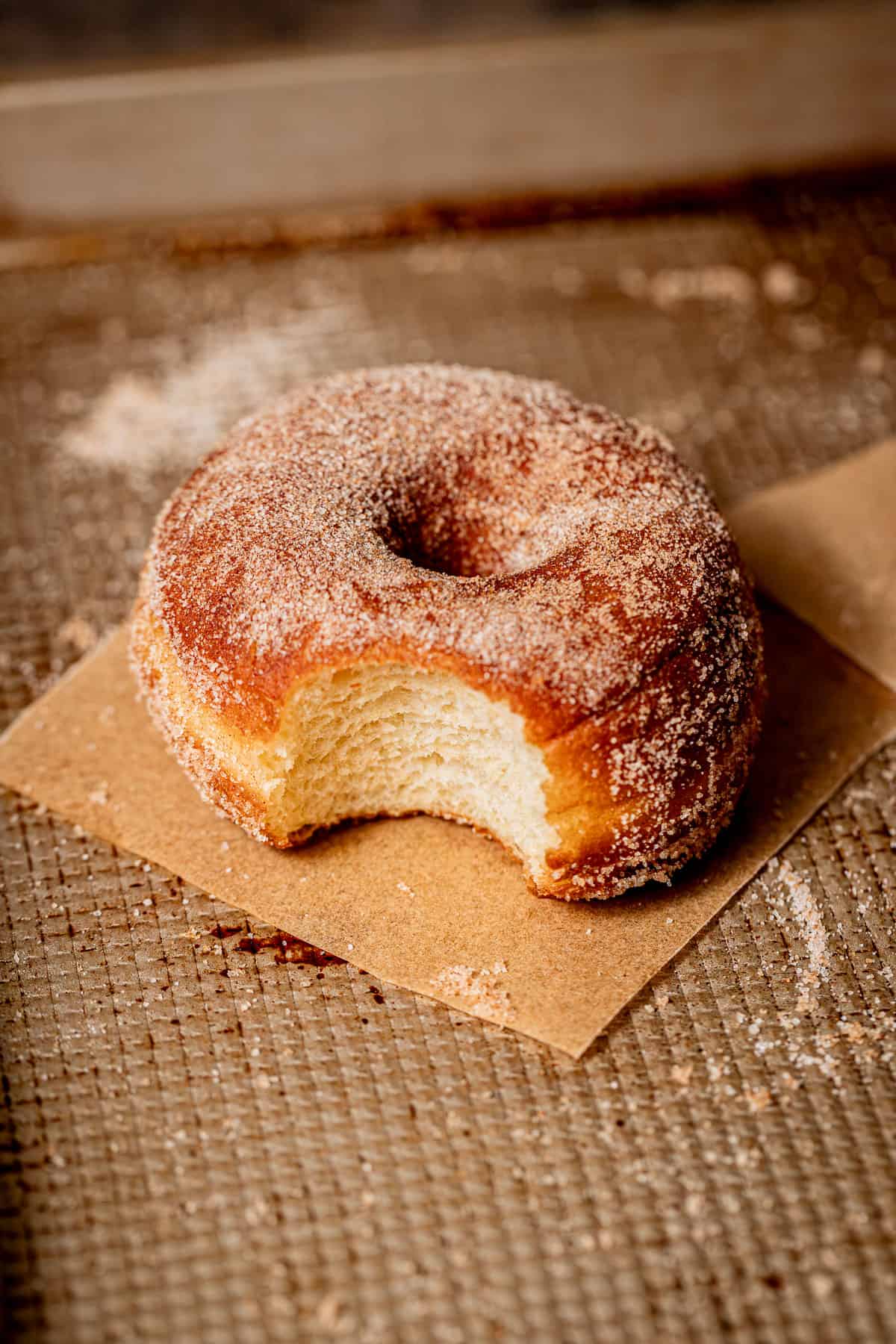 cinnamon sugar brioche donut on baking sheet.