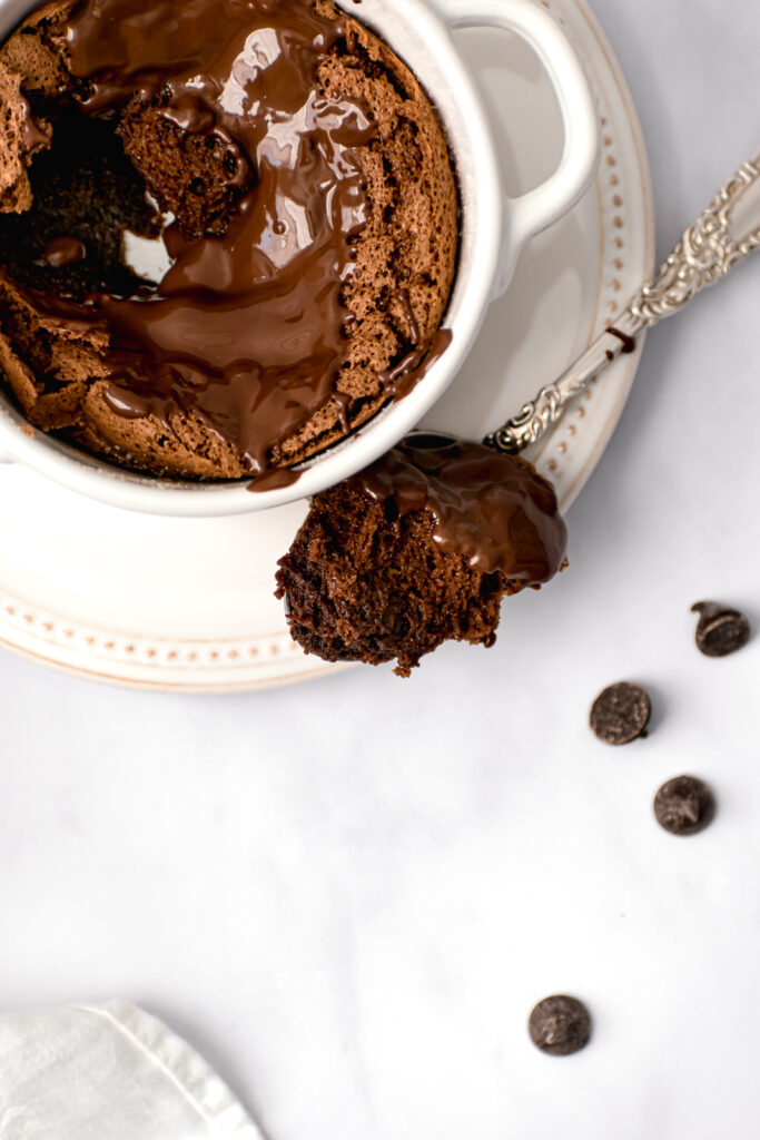 mini chocolate soufflé for one with melted chocolate on top and silver spoon