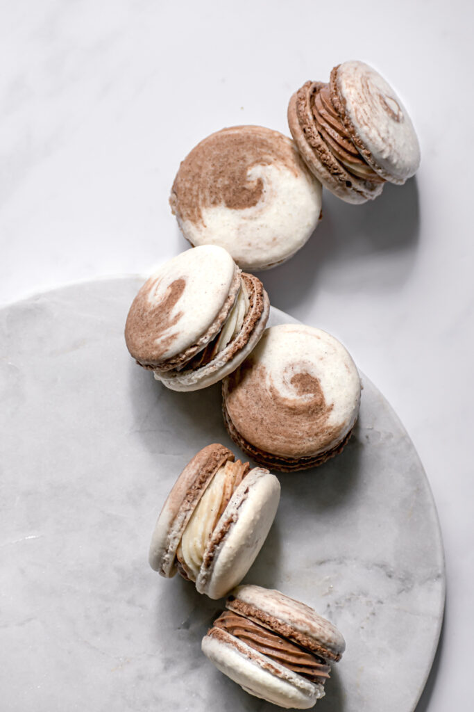 Chocolate & Vanilla Swirled Macarons on marble