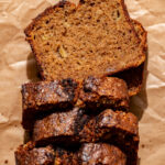 brown butter banana bread sliced on parchment paper