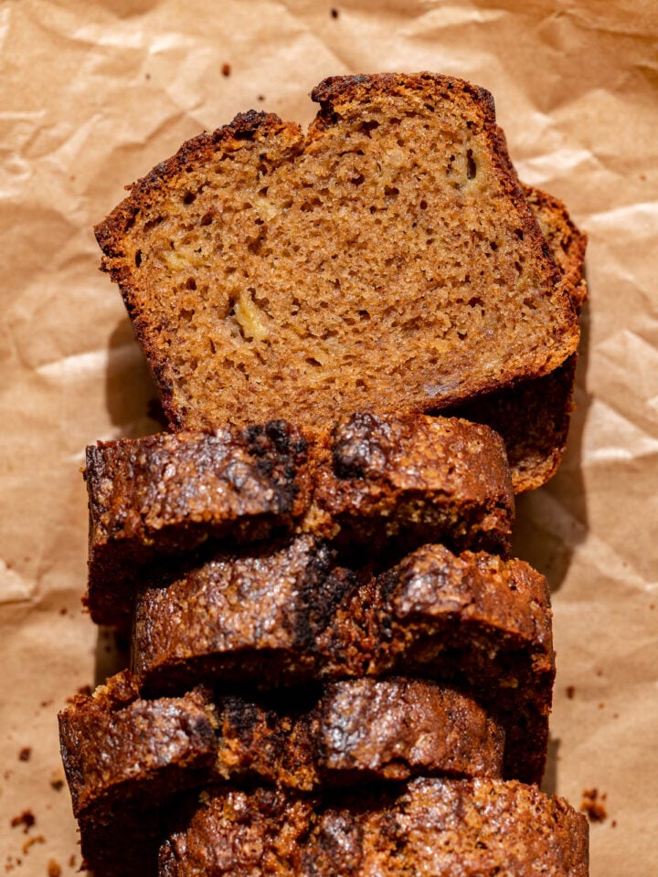 brown butter banana bread sliced on parchment paper