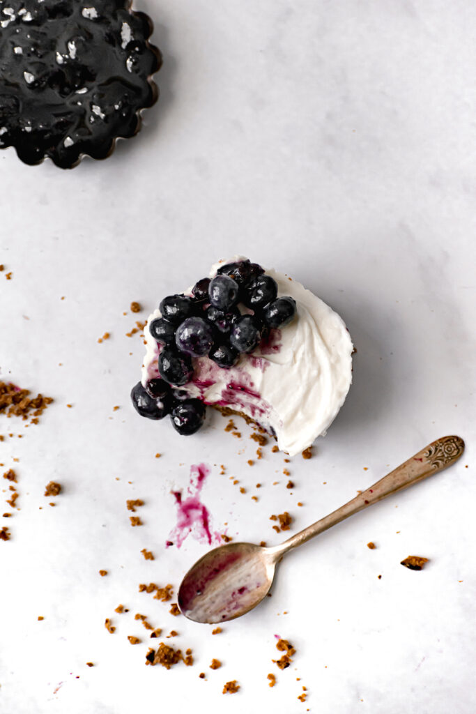 mini blueberry cream cheese chantilly tart with small spoon