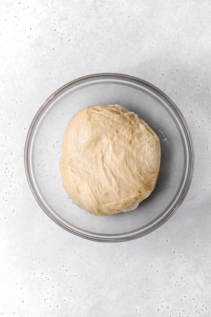 brioche dough in glass bowl