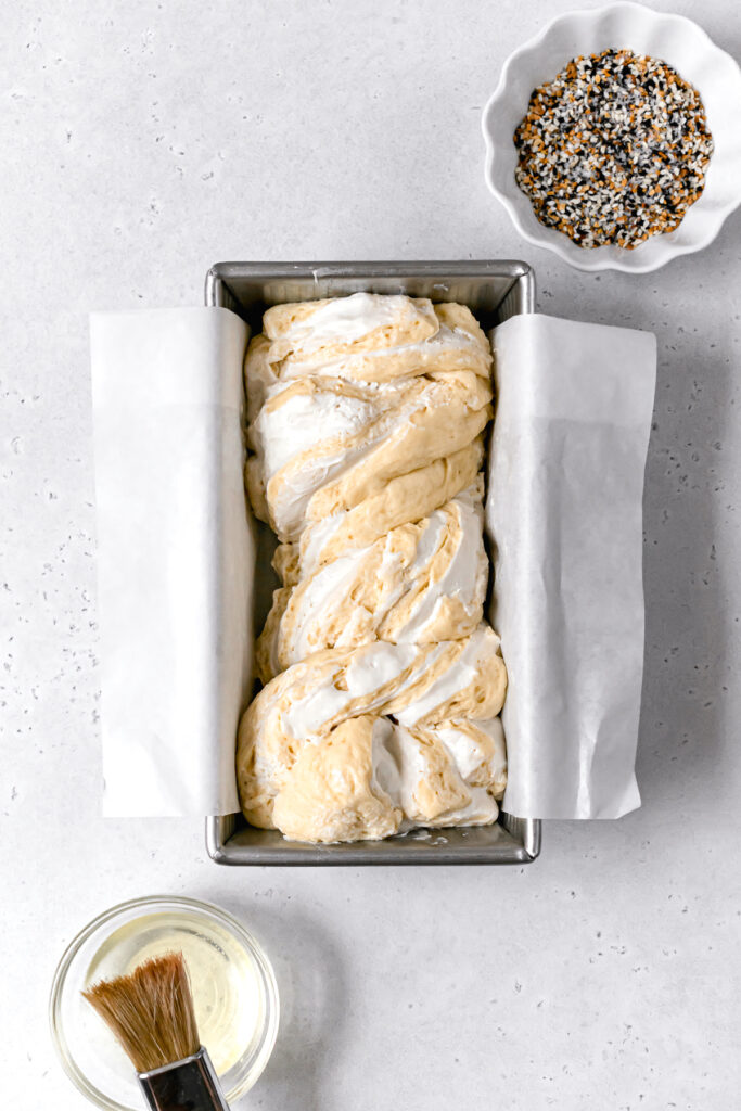 proofed babka dough in loaf pan 