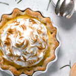 lemon meringue pie with fresh rosemary crust in white pie dish