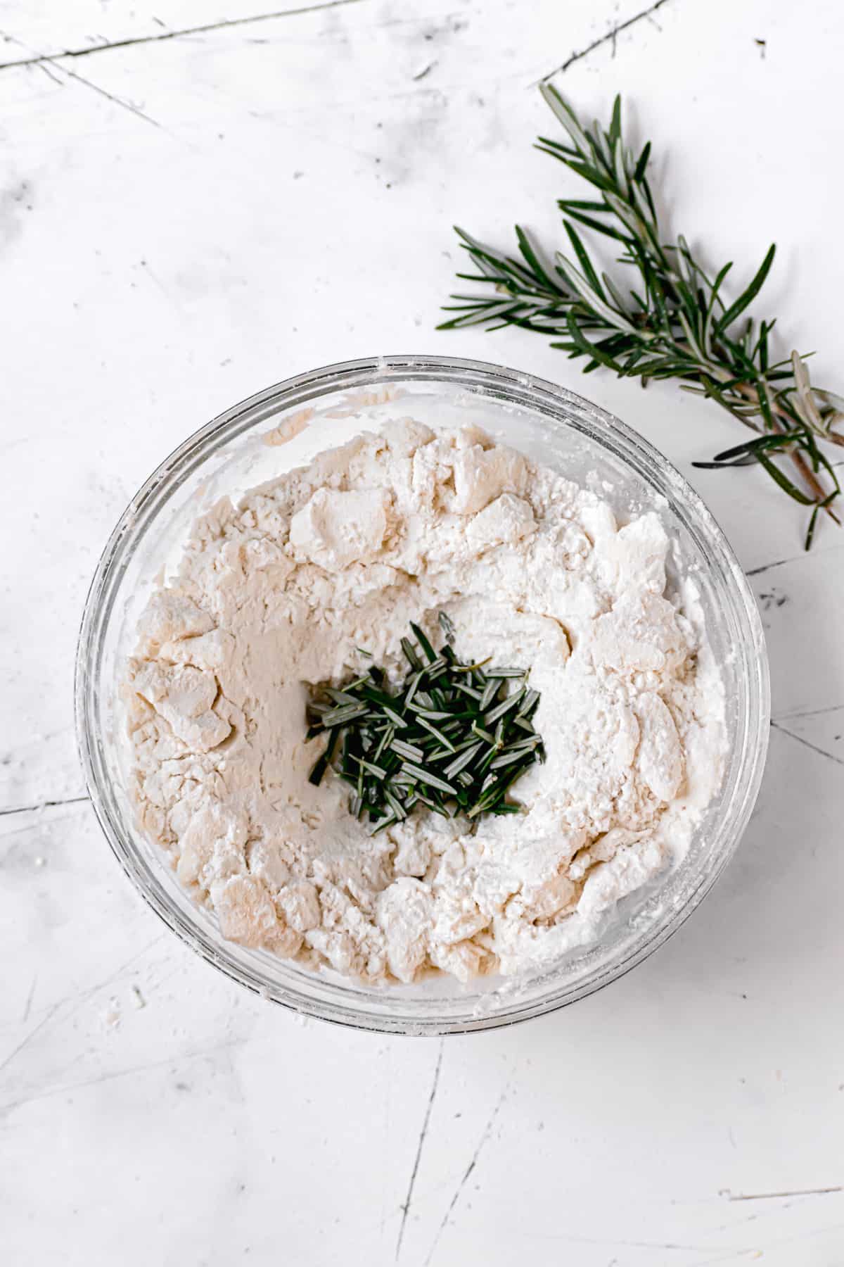 butter properly cut into the flour with rosemary in the center.