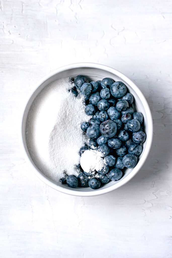 blueberries, sugar, and cornstarch in white bowl