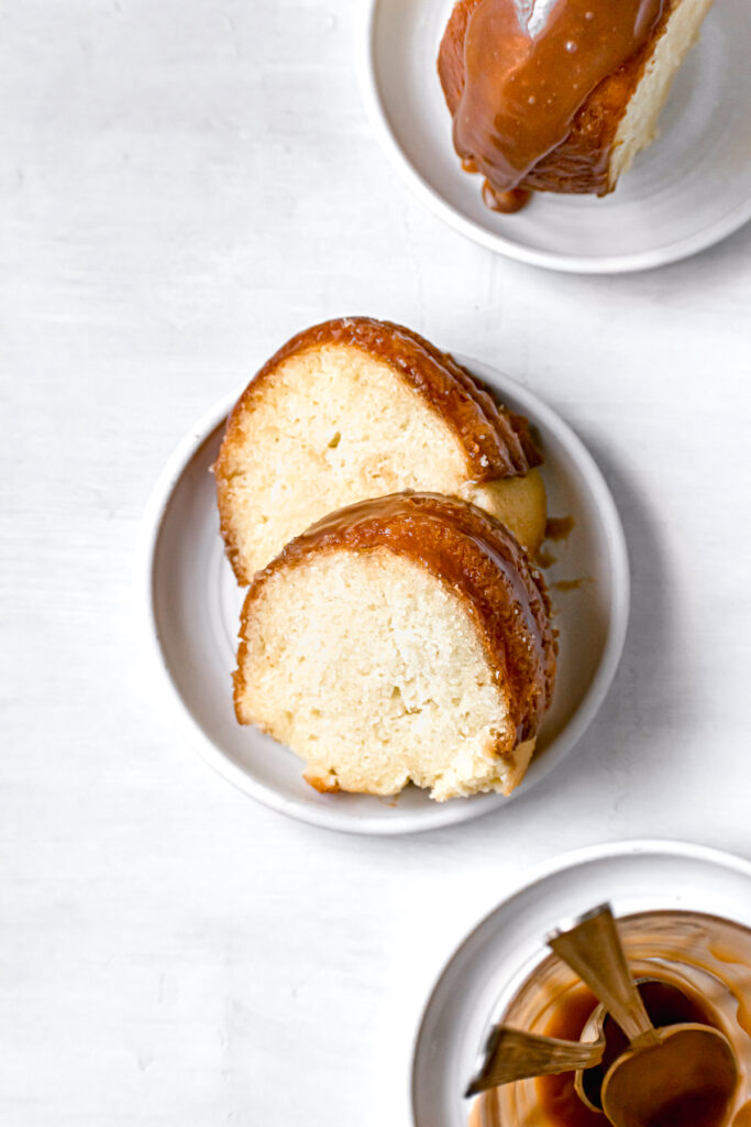 two slices of caramel rum bundt cake on small white plate