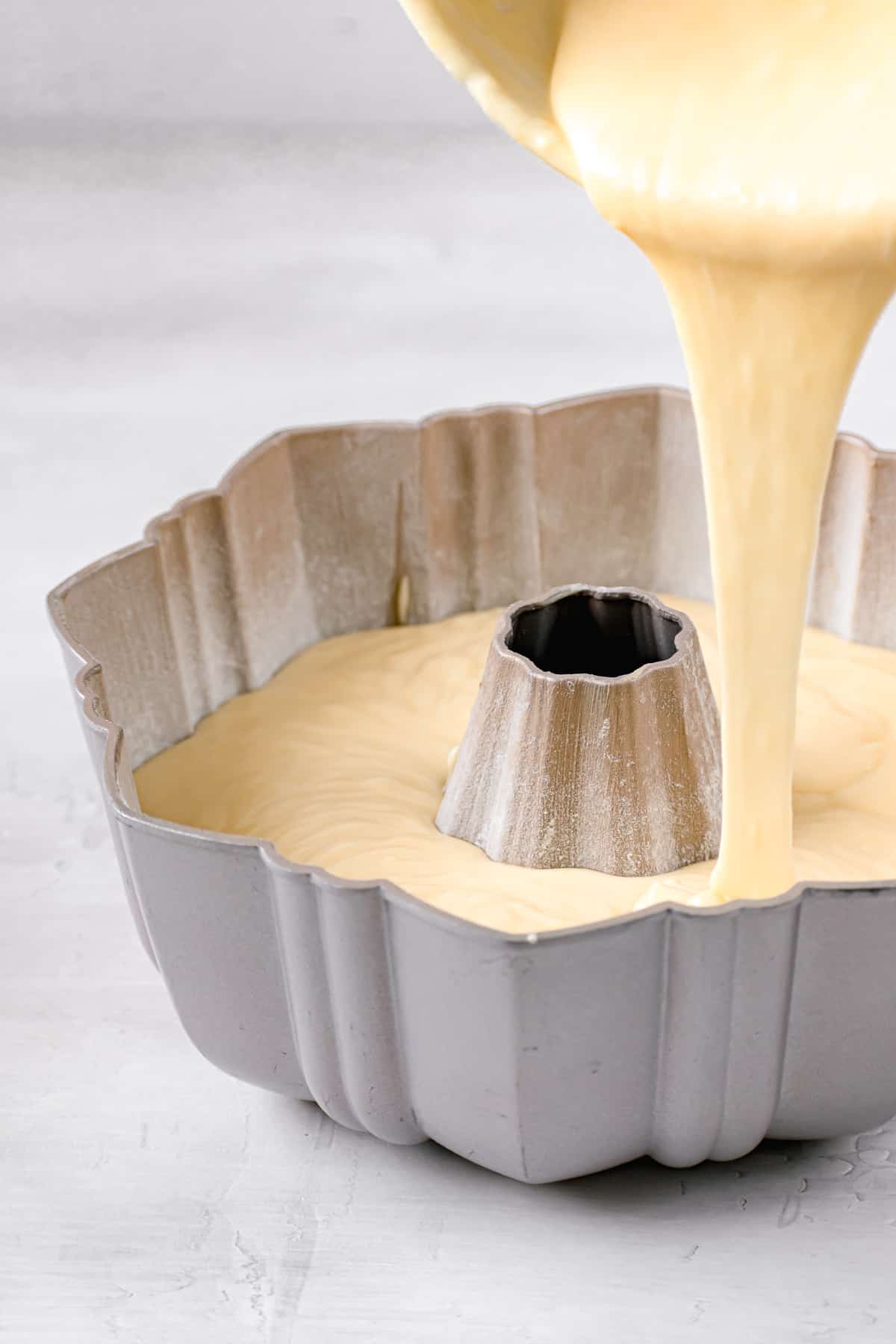 batter being poured into bundt pan.