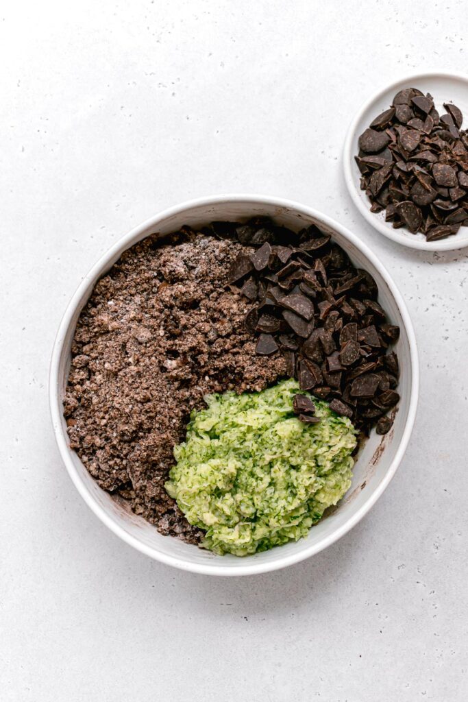 grated zucchini and chopped chocolate over crumbly mixture in large bowl