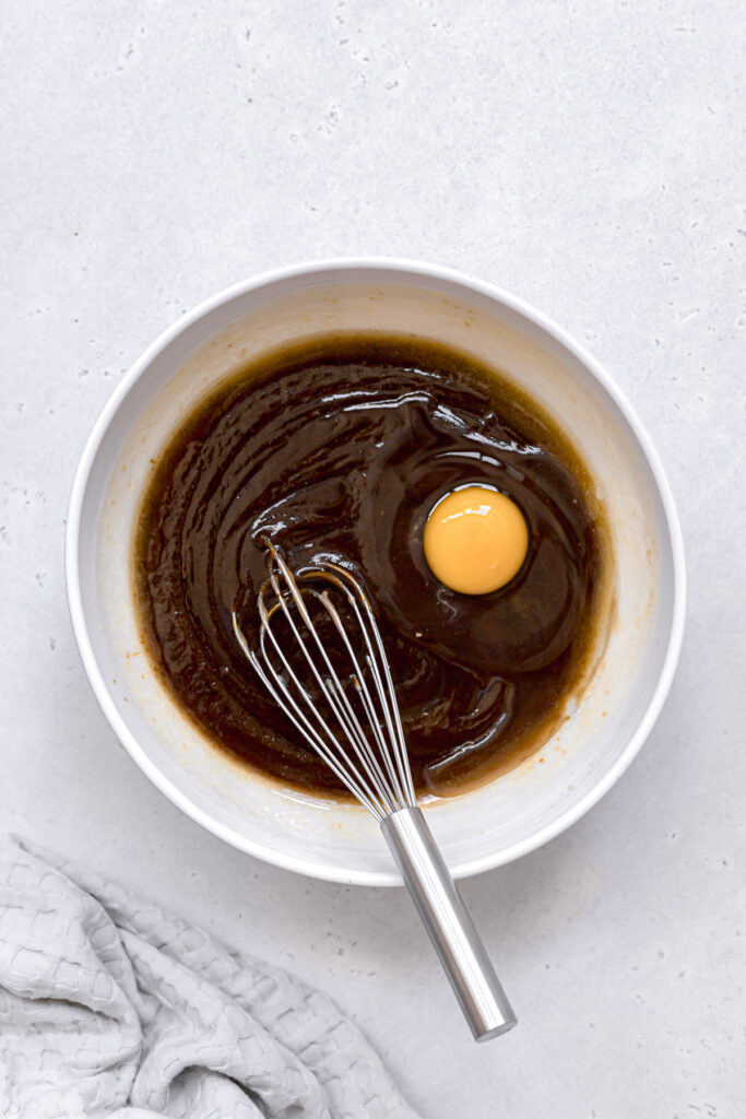 egg being whisked into wet ingredients