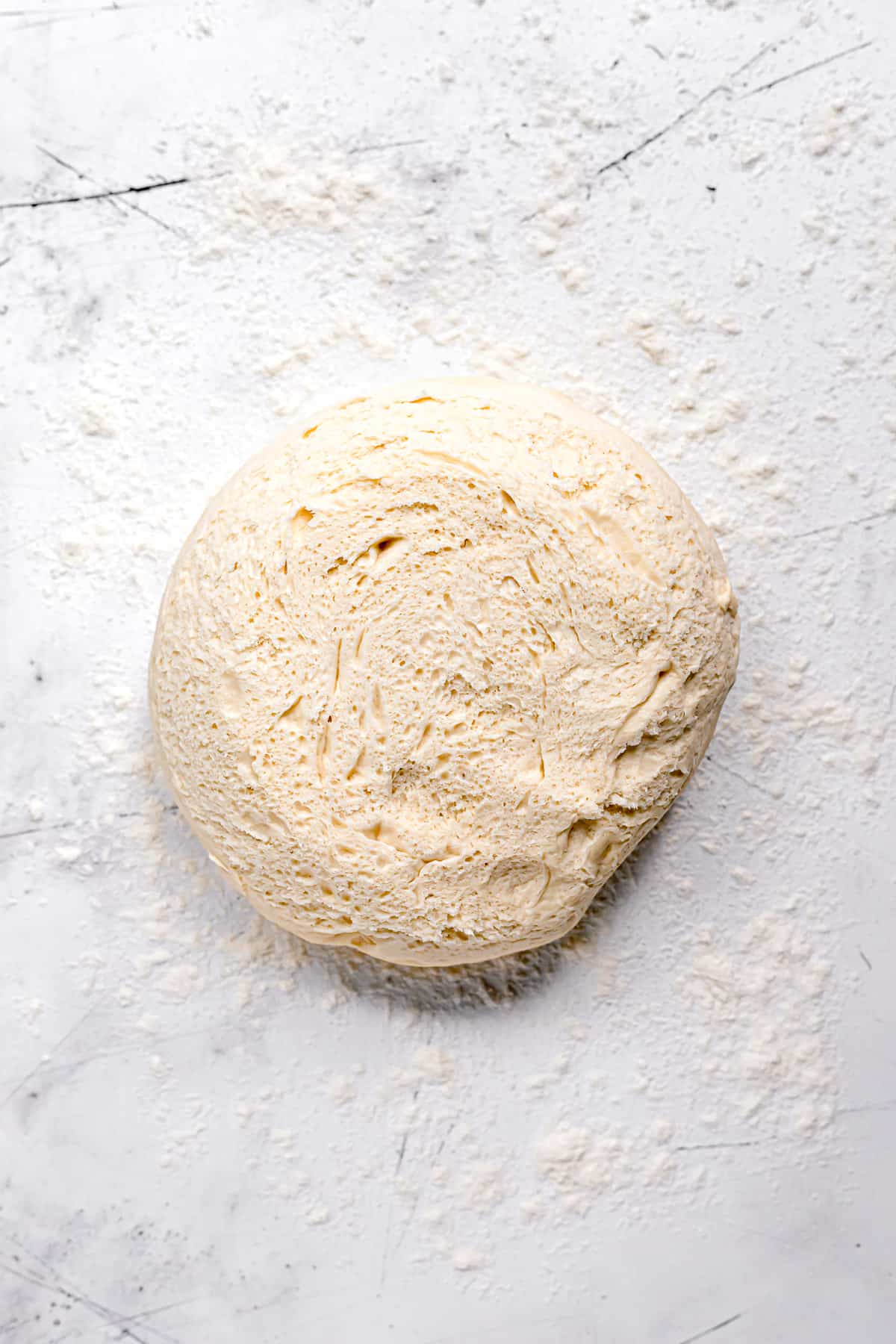 brioche dough on floured surface.