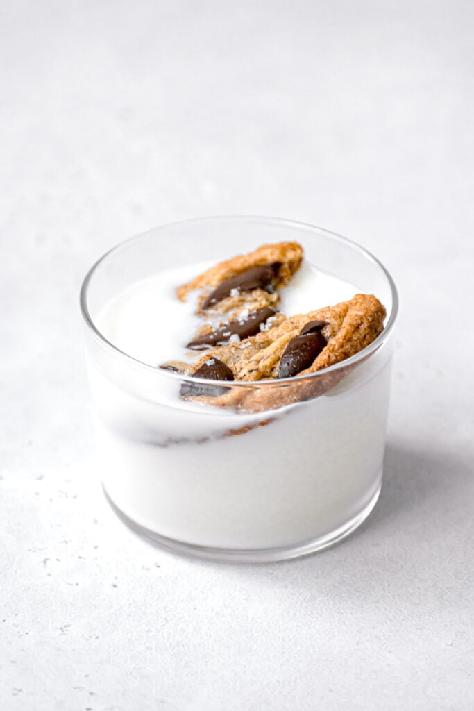 cookie dunked in glass of milk