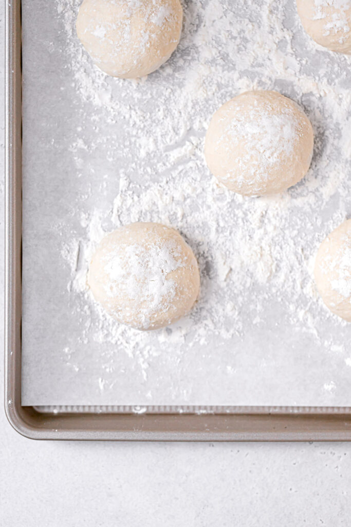 dough divided into 12 balls on baking sheet