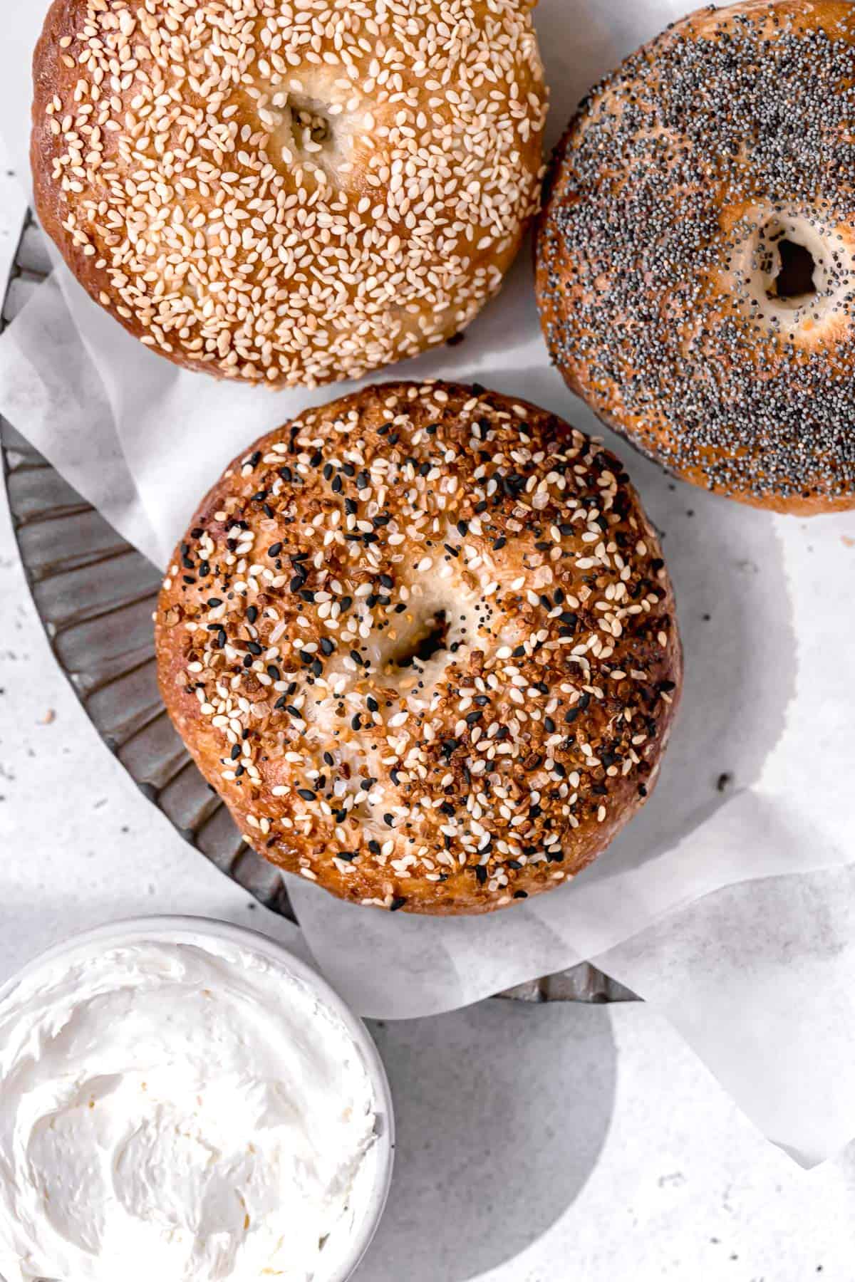three ny style bagels with everything bagel seasoning, sesame seeds, and poppy seeds.