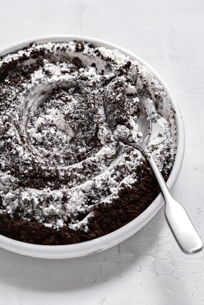 black cocoa powder mixed in flour in white bowl