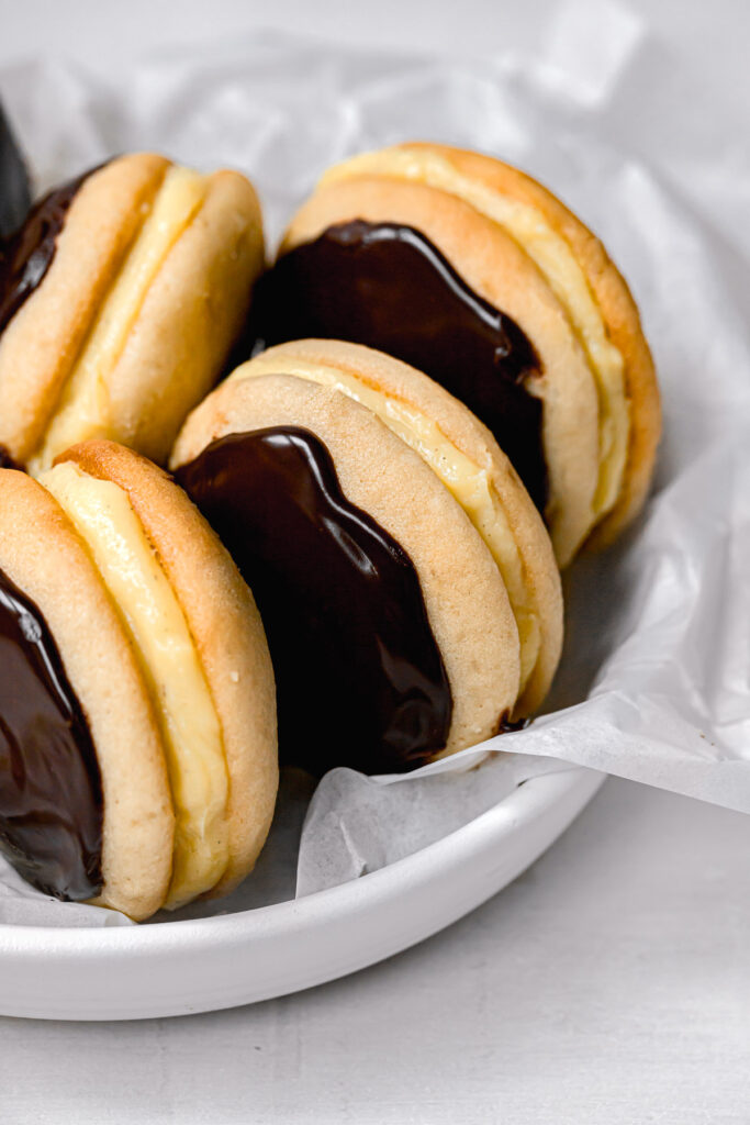 boston cream whoopie pies lined up in white bowl