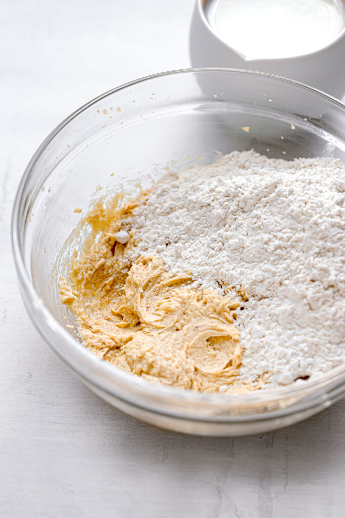 dry ingredients added to batter in glass bowl