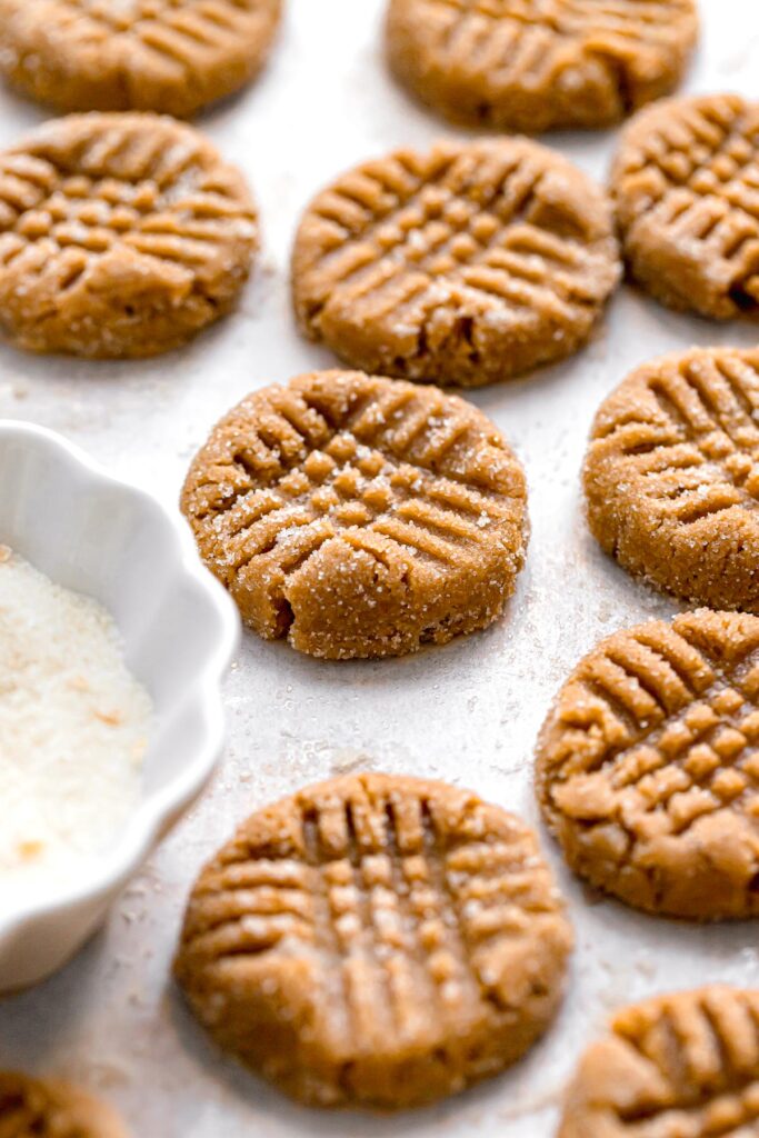 peanut butter cookie dough rolled in sugar with criss-cross fork indentations