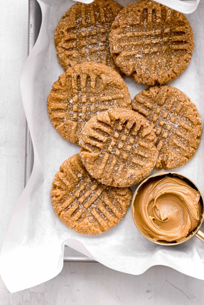 6 ingredient peanut butter cookies on parchment lined baking sheet