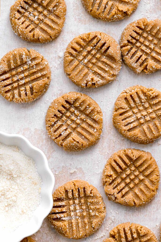 6 ingredient peanut butter cookie dough rolled in sugar with criss-cross fork indentations