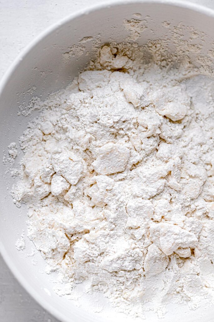butter cut into flour in white bowl