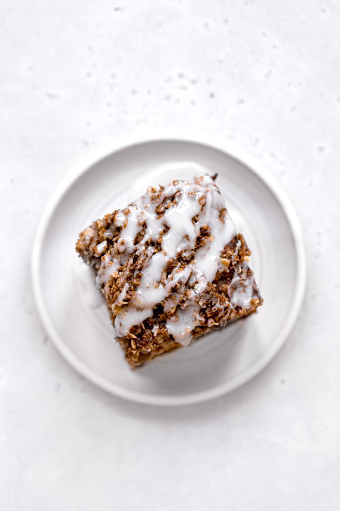 one piece of apple sour cream cake on white plate