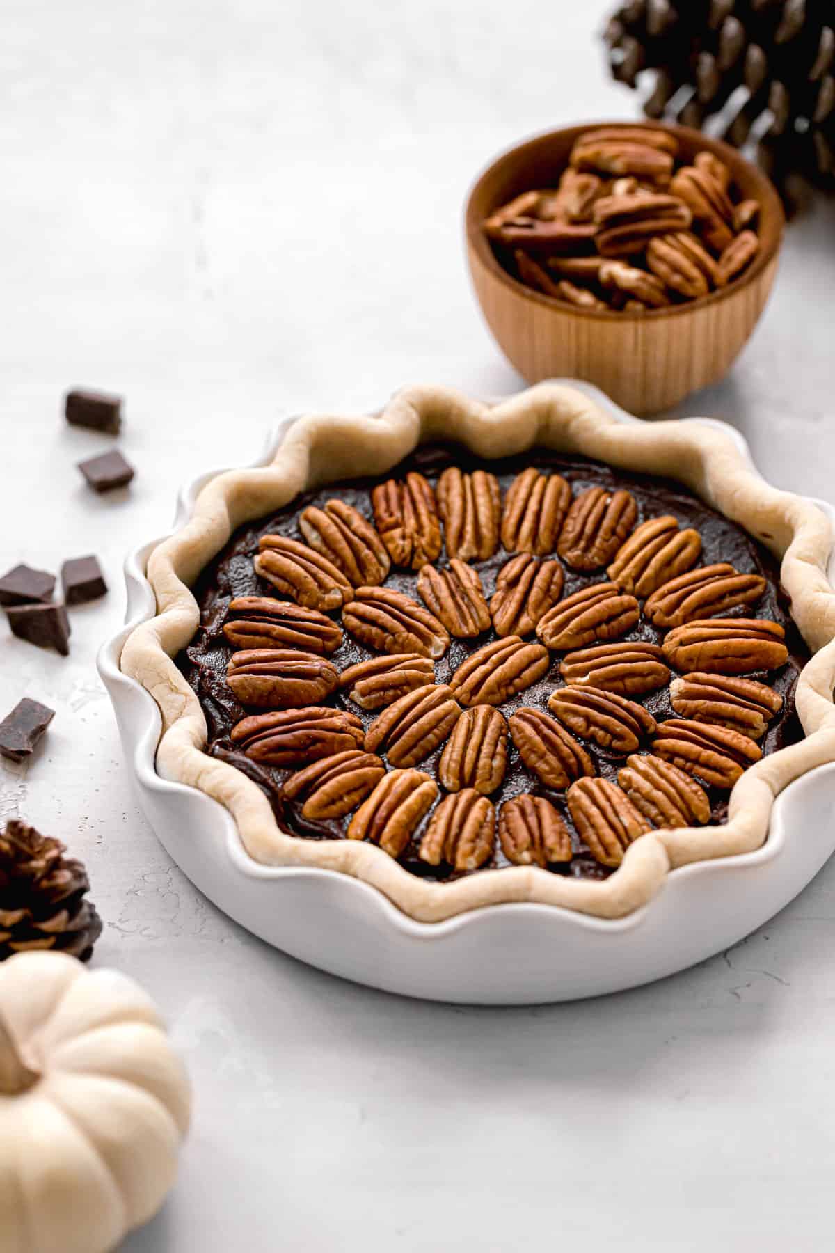 unbaked brownie pie with pecans on top.