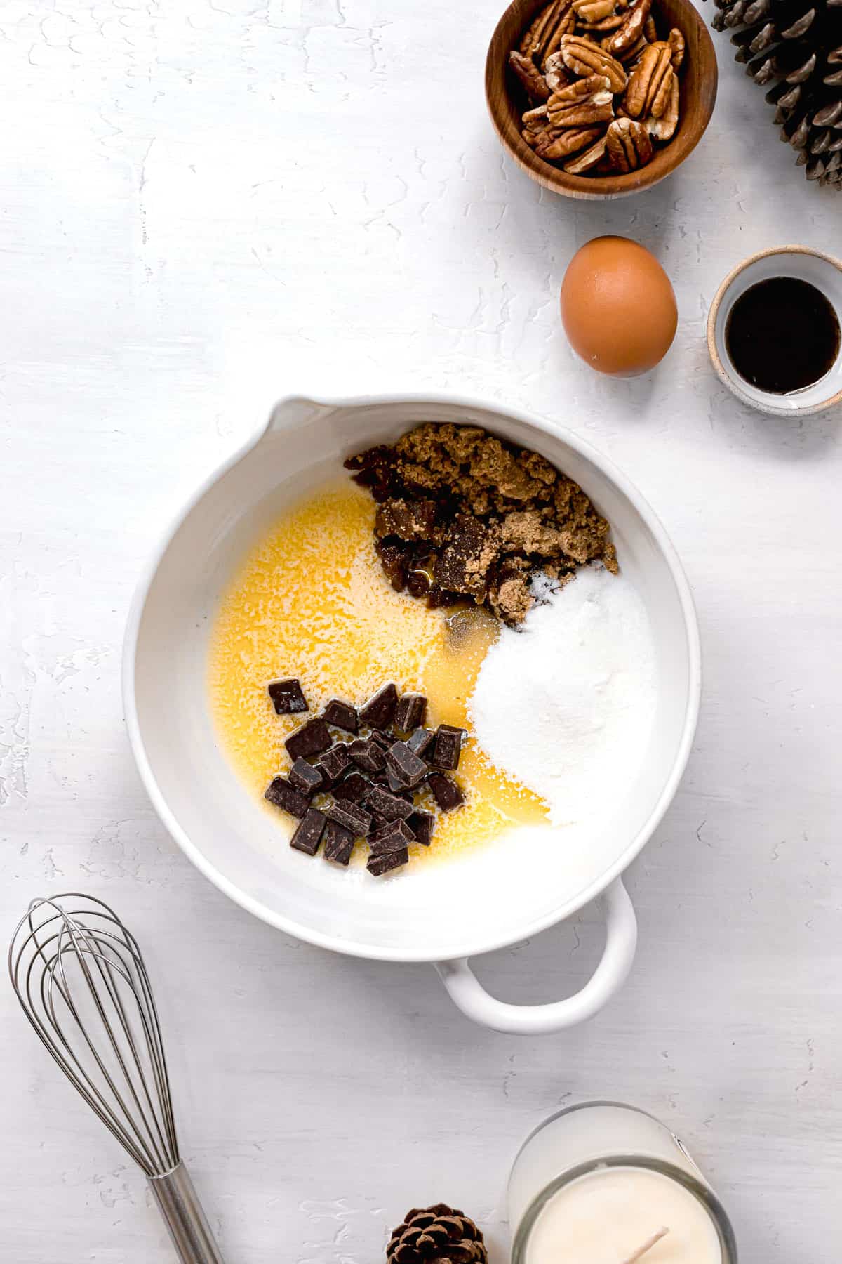 melted butter, sugars, and chocolate in white bowl.