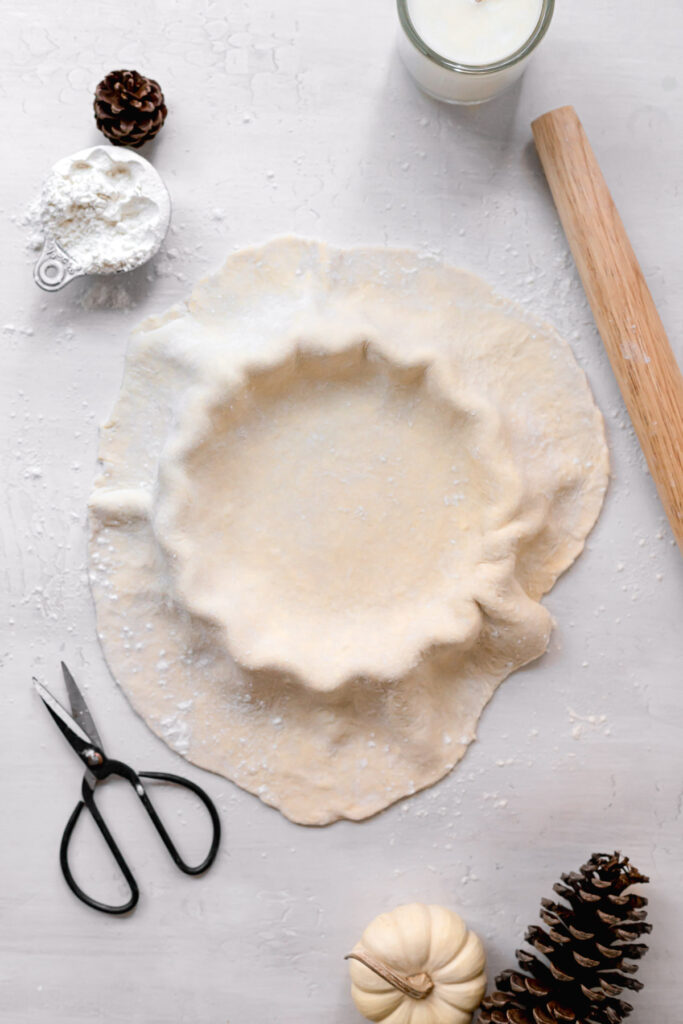 rolled out pie crust draped over pie dish