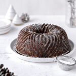 gingerbread bunt cake with powdered sugar on white plate
