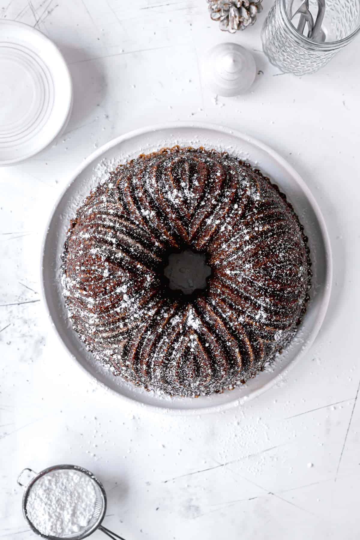 overhead view of gingerbread bundt cake with powdered sugar dusted on top.